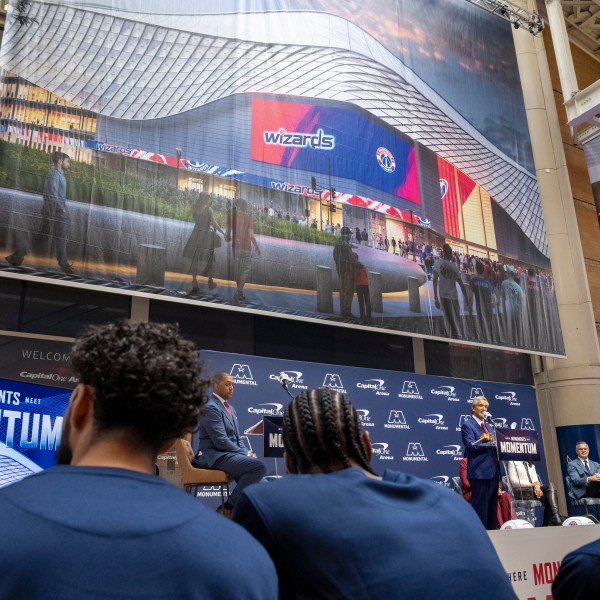 Members of the Washington Wizards NBA Basketball team listen as Ted Leonsis, owner of the Washington Wizards NBA basketball team and Washington Capitals NHL hockey team, speaks during an event announcing the start of work on a new Capital One Arena Gallery Place Atrium, Thursday, Dec. 19, 2024, in Washington. (AP Photo/Jacquelyn Martin)