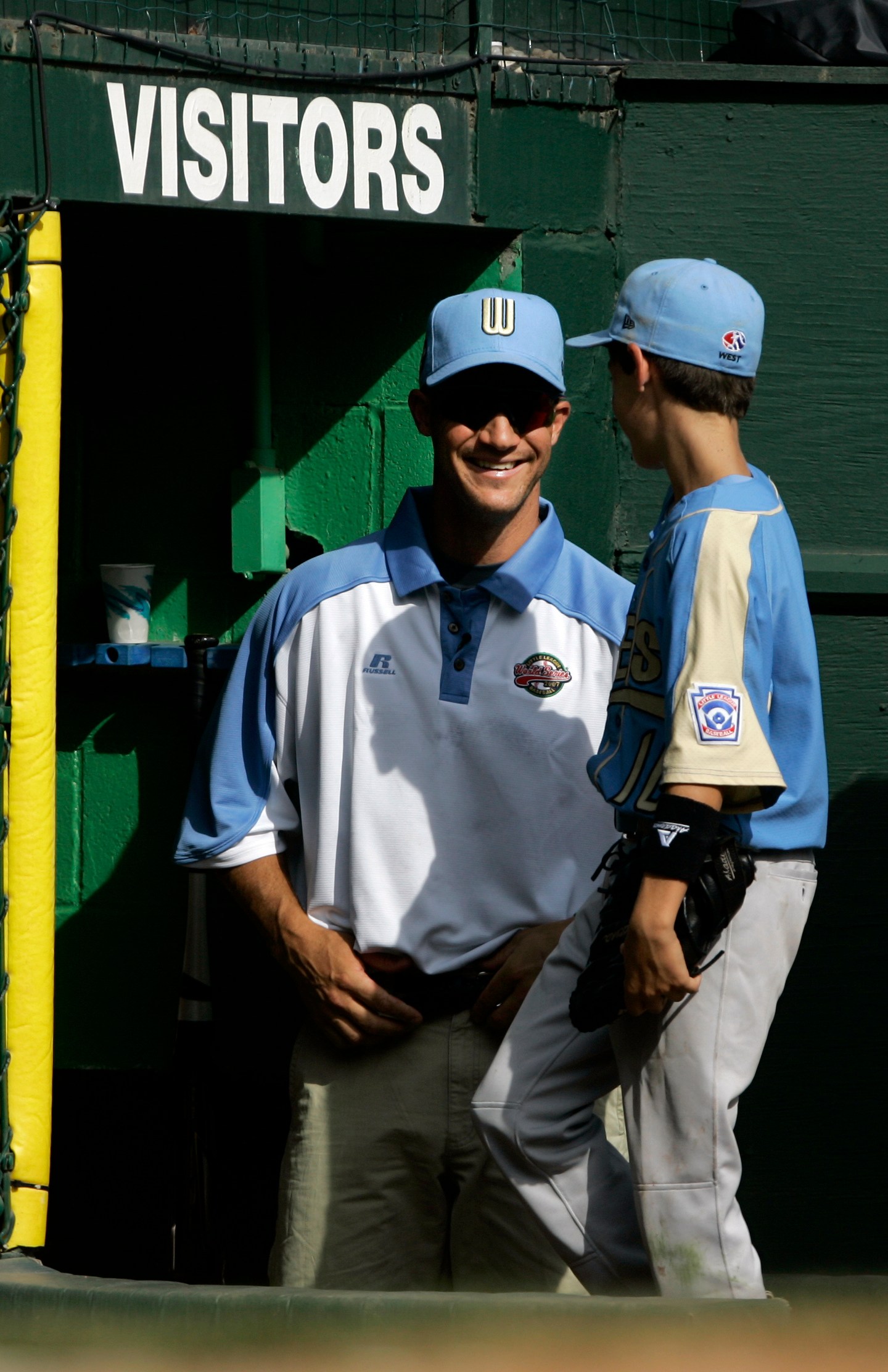 FILE - Chandler Ariz., coach Clay Bellinger, left, smiles at his son and Arizona player Cody Bellinger as they come into the dugout in the third inning against Salisbury, Md., during the 2007 Little League World Series pool play in South Williamsport, Pa., on Saturday, Aug. 18, 2007. (AP Photo/Carolyn Kaster, File)