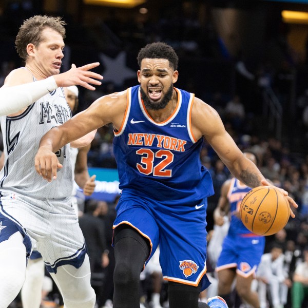 New York Knicks center Karl-Anthony Towns (32) drives against Orlando Magic center Moritz Wagner, left, during the first half of an NBA basketball game Sunday, Dec. 15, 2024, in Orlando, Fla. (AP Photo/Alan Youngblood)