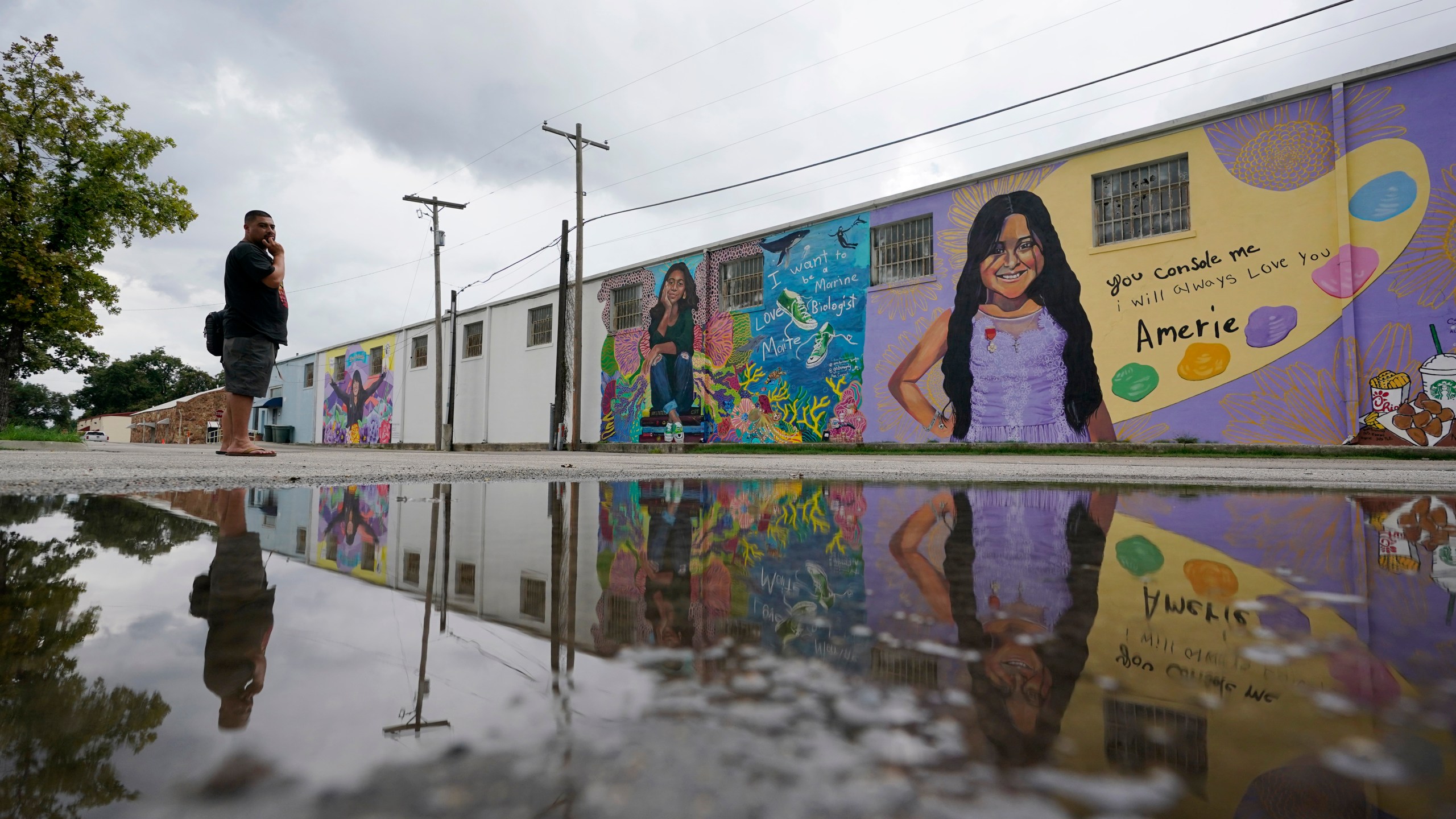 FILE - A couple visits murals created to honor the victims of the shootings at Robb Elementary School, Aug. 25, 2022, in Uvalde, Texas. (AP Photo/Eric Gay, file)