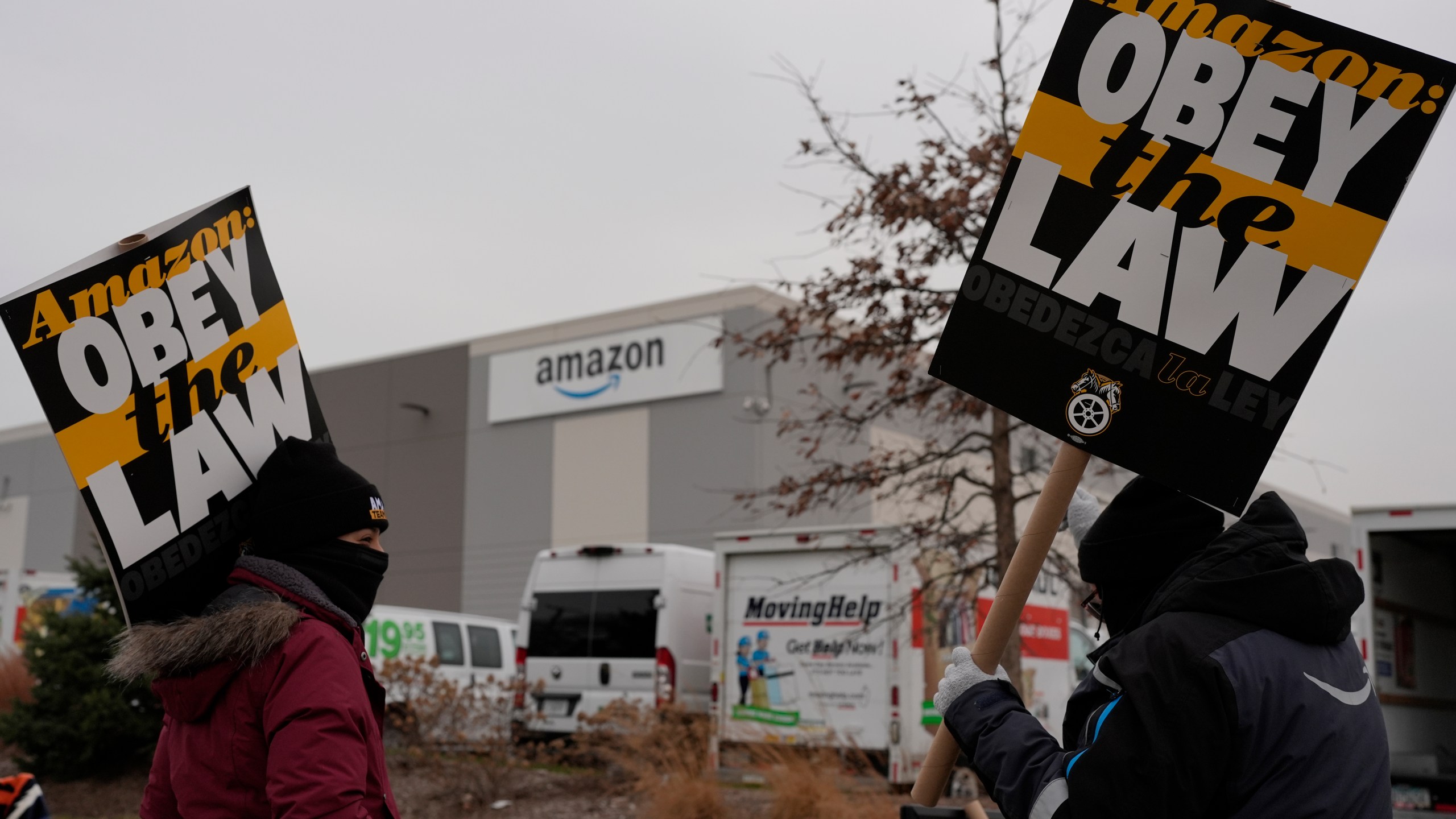 Strikers hold signs during a strike at Skokie (DIL7) Amazon Delivery station in Skokie, Ill., Thursday, Dec. 19, 2024. (AP Photo/Nam Y. Huh)