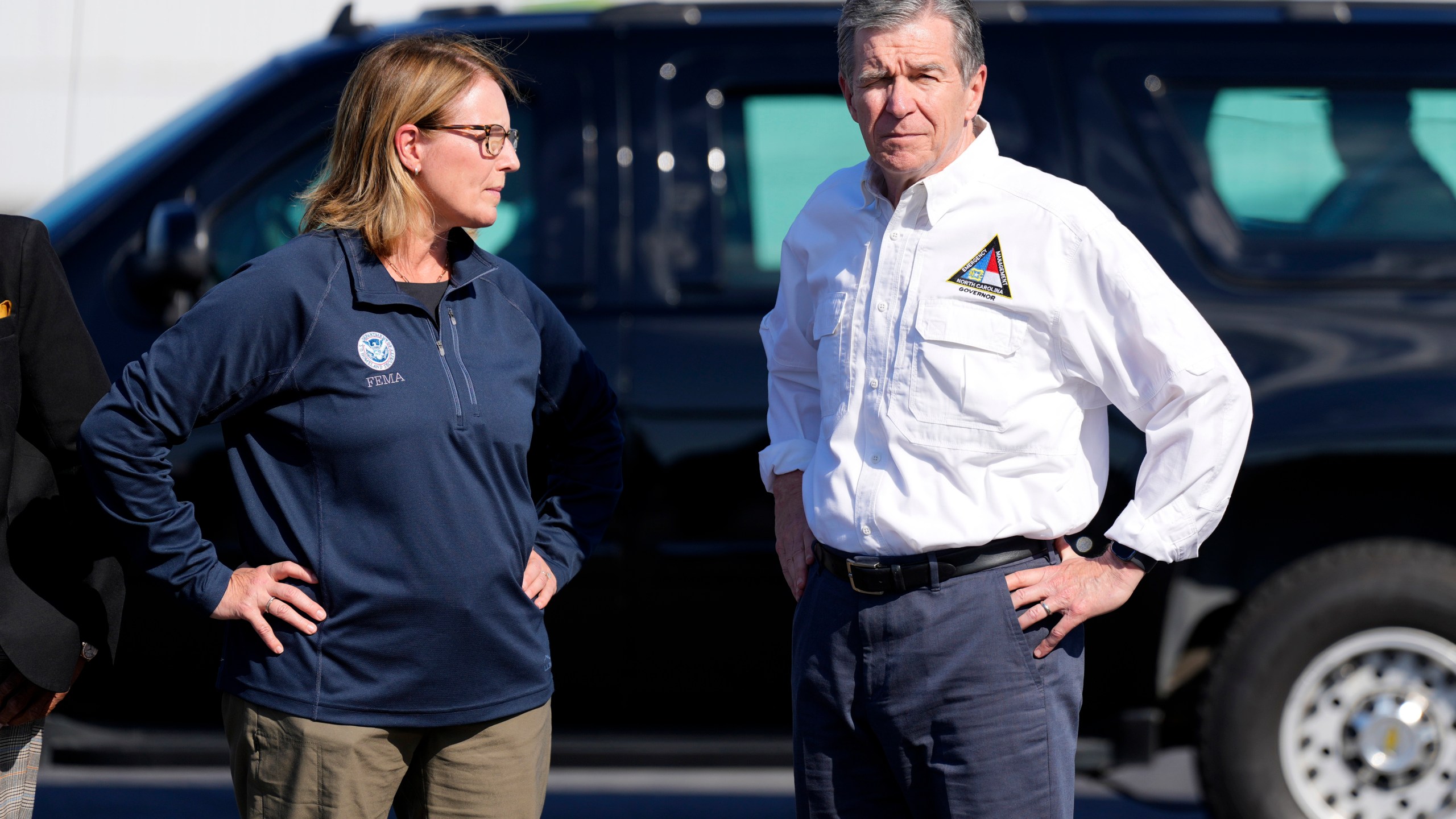 FILE- North Carolina Gov. Roy Cooper, right, and Deanne Criswell, Administrator of the U.S. Federal Emergency Management Agency, await the arrival of Democratic presidential nominee Vice President Kamala Harris for a briefing on the damage from Hurricane Helene, at Charlotte Douglas International Airport, in Charlotte, N.C., Oct. 5, 2024. (AP Photo/Chris Carlson, File)