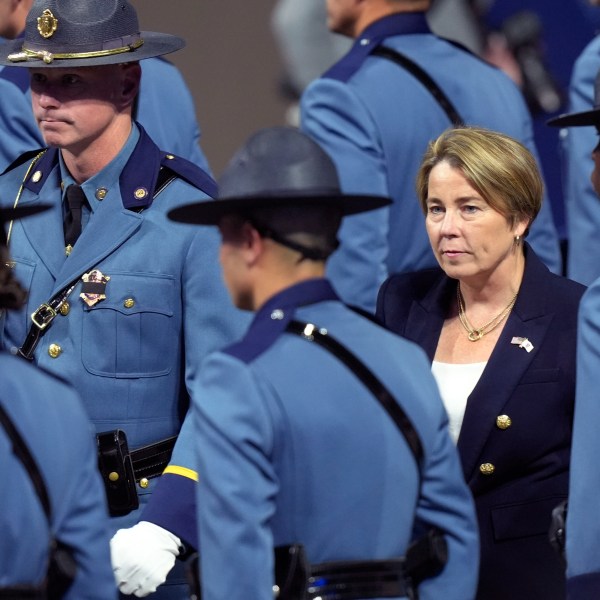 FILE - Massachusetts Gov. Maura Healey, right, walks among members of the 90th Recruit Training Group of the Massachusetts State Police, during a swearing in ceremony in Worcester, Mass., Oct. 9, 2024. (AP Photo/Steven Senne, File)