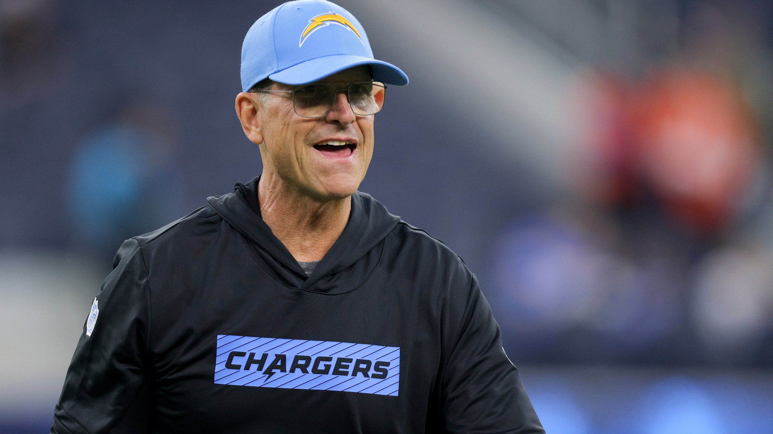 Los Angeles Chargers head coach Jim Harbaugh walks on the field before an NFL football game against the Denver Broncos, Thursday, Dec. 19, 2024, in Inglewood, Calif. (AP Photo/Ryan Sun)