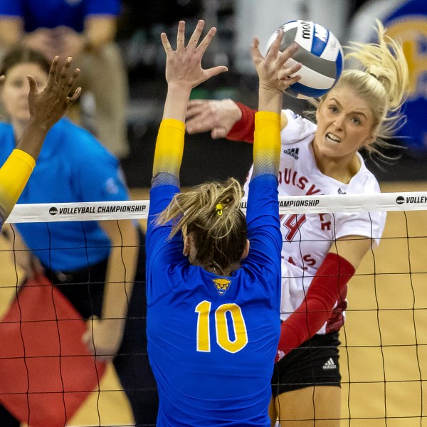 FILE - Louisville's Anna DeBeer, right, spikes the ball against Pittsburgh's Rachel Fairbanks (10) in the third set during the semifinals of the NCAA volleyball tournament Dec. 15, 2022, in Omaha, Neb. (AP Photo/John S. Peterson, File)