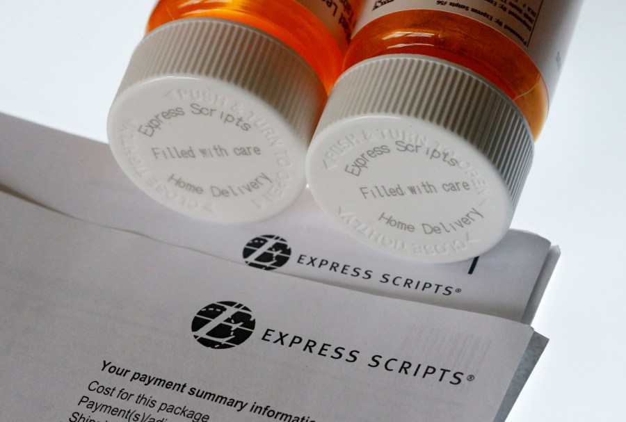 FILE - In this Tuesday, July 25, 2017, file photo, Express Scripts prescription medication bottles are arranged for a photo, in Surfside, Fla. (AP Photo/Wilfredo Lee, File)