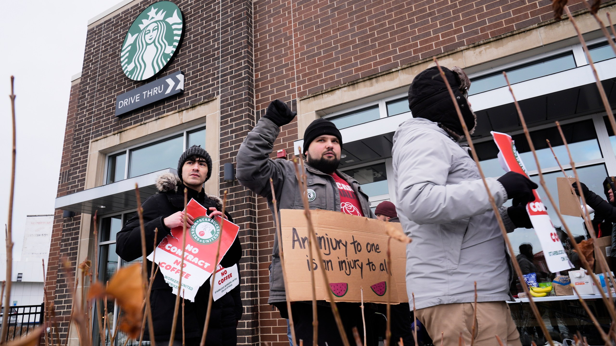 Employees picket outside a Starbucks store, Friday, Dec 20, 2024, in Chicago. (AP Photo/Kiichiro Sato)