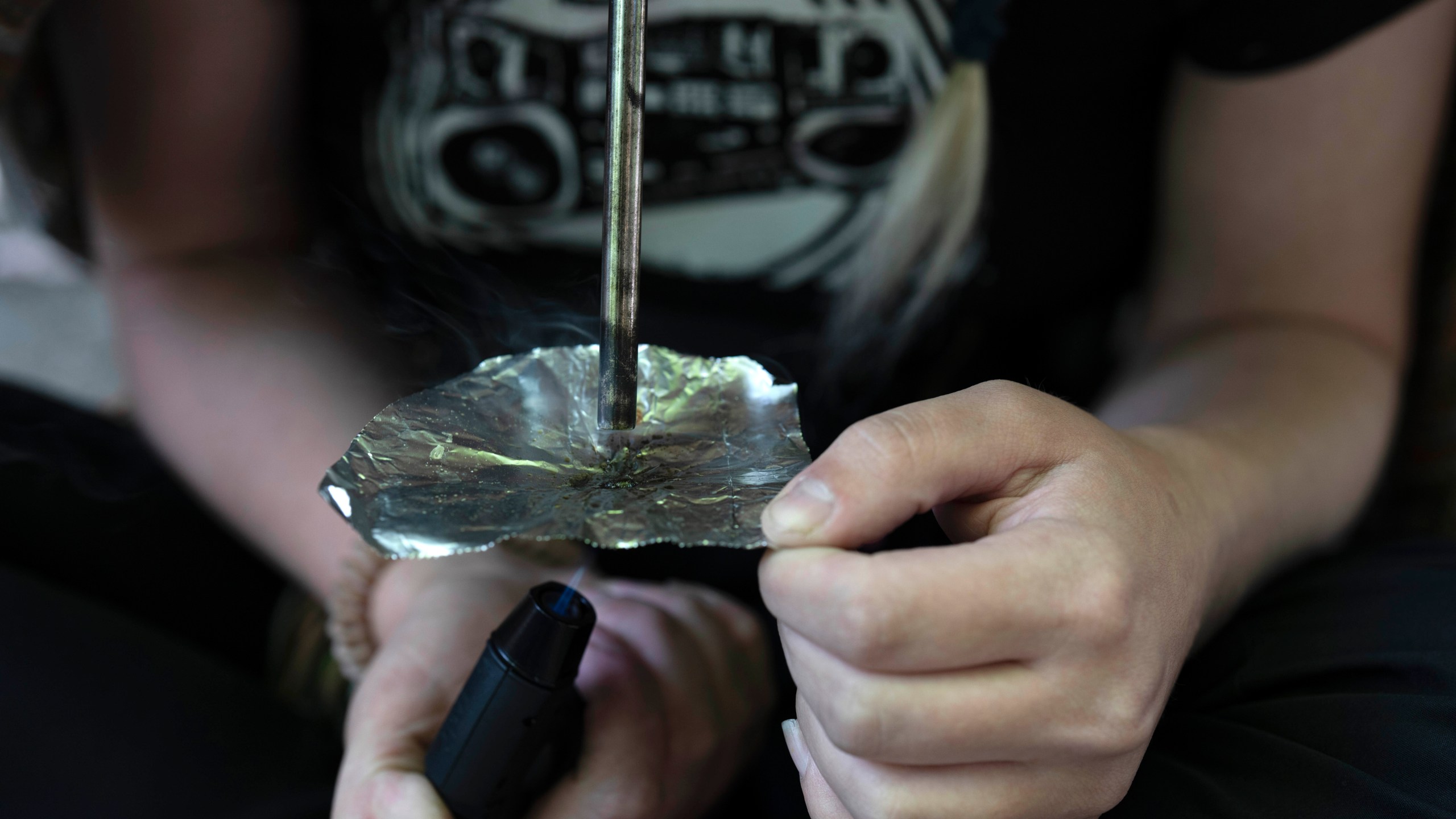 FILE - A homeless person smokes fentanyl on Friday, June 28, 2024, in Portland, Ore. (AP Photo/Jenny Kane, File)