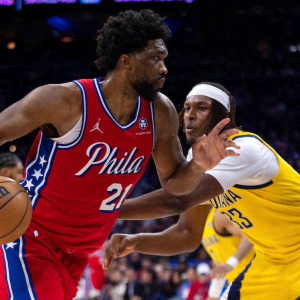 Philadelphia 76ers' Joel Embiid, left, drives to the basket against Indiana Pacers' Myles Turner, right, during the first half of an NBA basketball game, Friday, Dec. 13, 2024, in Philadelphia. (AP Photo/Chris Szagola)