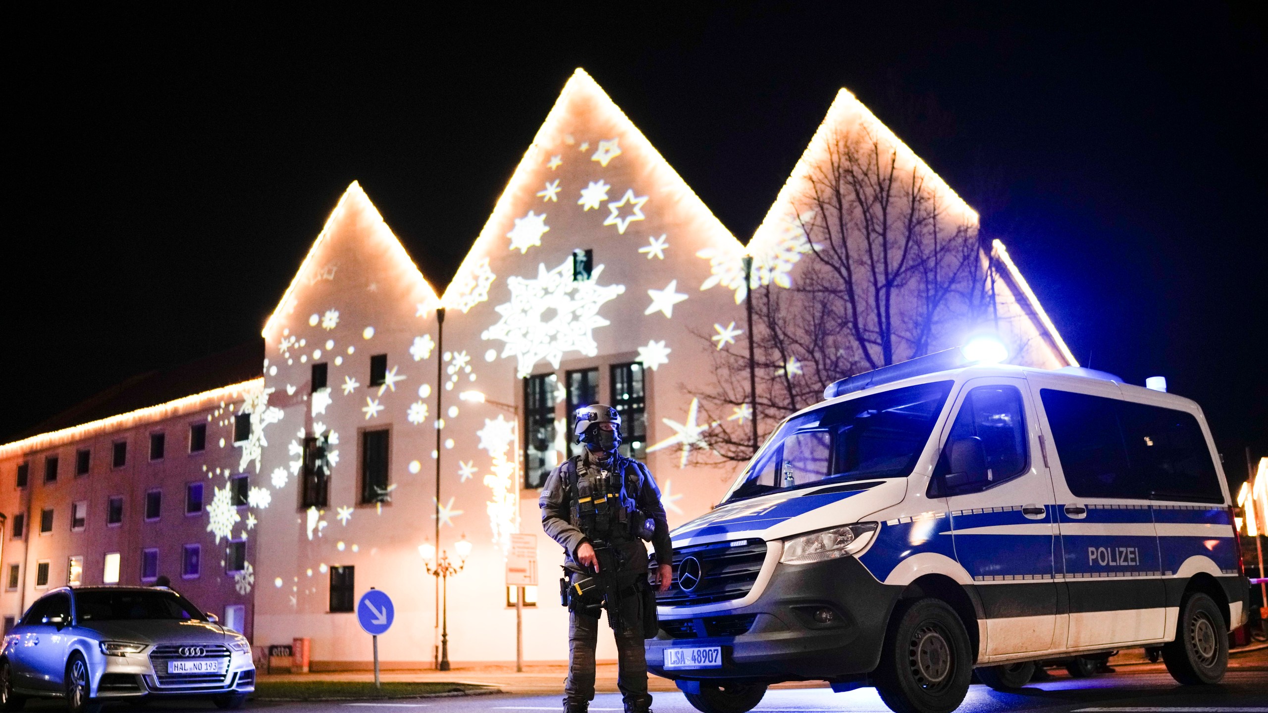 A police officer guards at a blocked road near a Christmas market after an incident in Magdeburg, Germany, Friday, Dec. 20, 2024. (AP Photo/Ebrahim Noroozi)