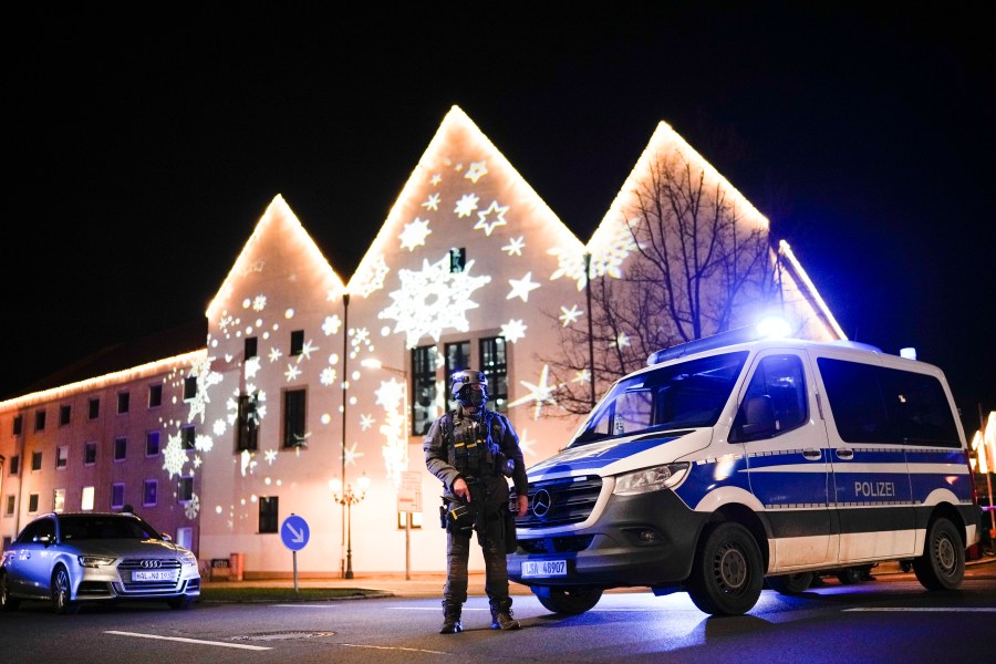 A police officer guards at a blocked road near a Christmas market after an incident in Magdeburg, Germany, Friday, Dec. 20, 2024. (AP Photo/Ebrahim Noroozi)