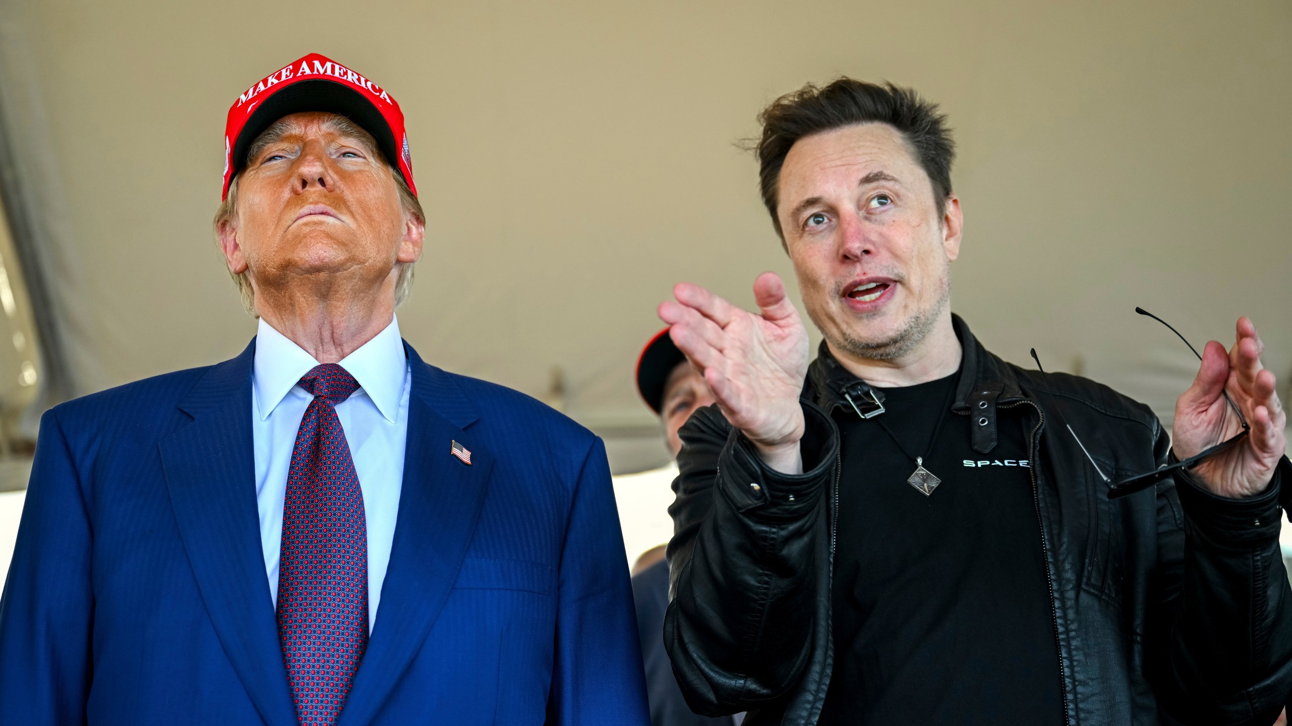 FILE - President-elect Donald Trump listens to Elon Musk as he arrives to watch SpaceX's mega rocket Starship lift off for a test flight from Starbase in Boca Chica, Texas, Nov. 19, 2024. (Brandon Bell/Pool via AP, File)