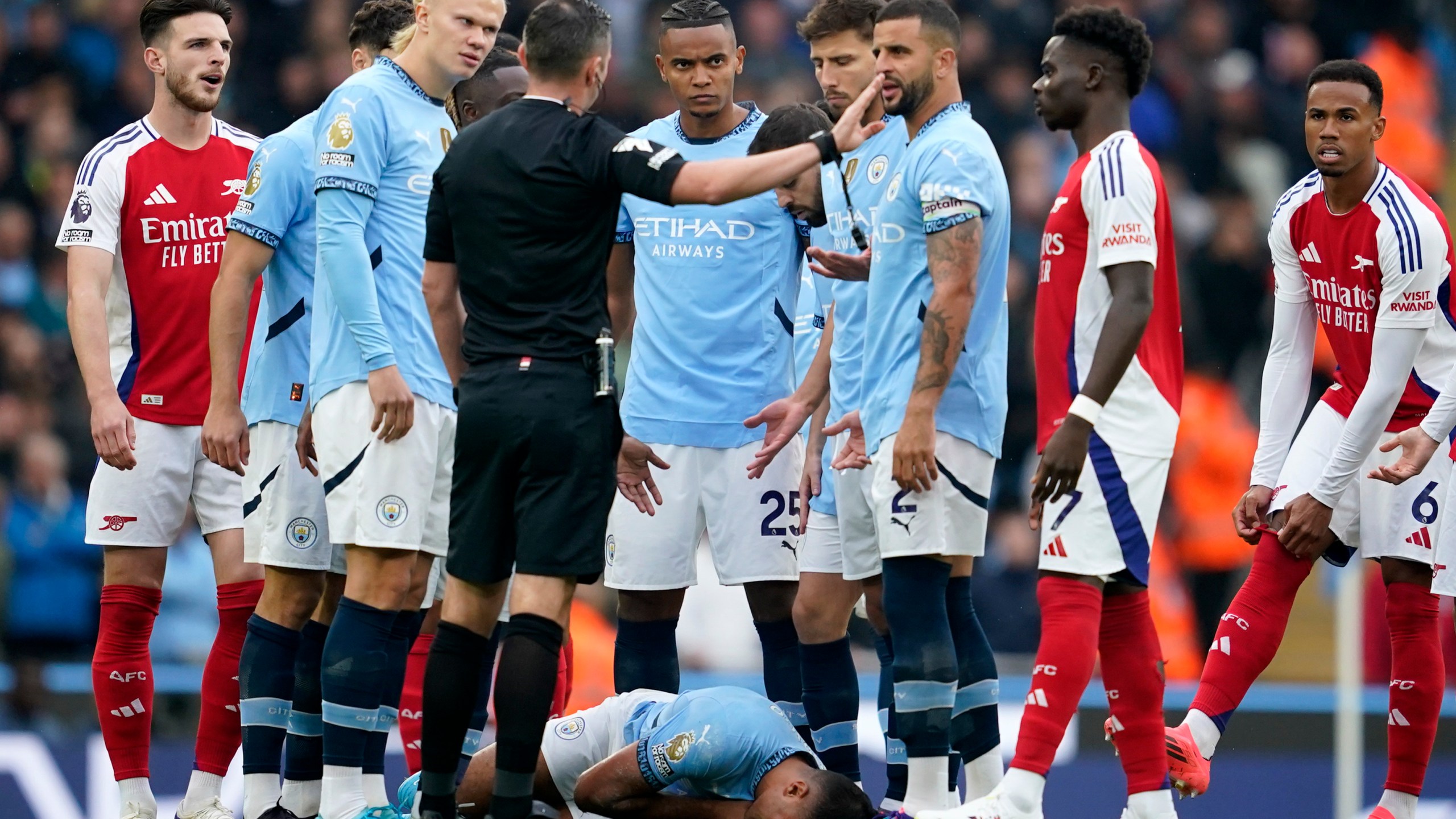 FILE - Manchester City's Rodri lays on the pitch after collision during the English Premier League soccer match between Manchester City and Arsenal at the Etihad stadium in Manchester, England, Sunday, Sept. 22, 2024. (AP Photo/Dave Thompson, File)