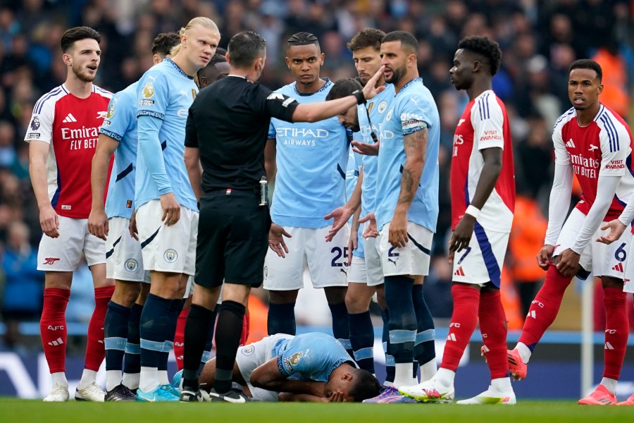 FILE - Manchester City's Rodri lays on the pitch after collision during the English Premier League soccer match between Manchester City and Arsenal at the Etihad stadium in Manchester, England, Sunday, Sept. 22, 2024. (AP Photo/Dave Thompson, File)