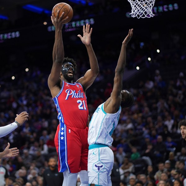 Philadelphia 76ers' Joel Embiid, left, goes up for a shot against Charlotte Hornets' Moussa Diabate during the second half of an NBA basketball game, Friday, Dec. 20, 2024, in Philadelphia. (AP Photo/Matt Slocum)