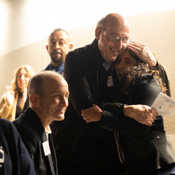 Benjamin Warren hugs Harris County Judge Lina Hidalgo after she spoke during a Chicanukah event at Holocaust Museum Houston on Thursday, December 19, 2024, in Houston. (AP Photo/Annie Mulligan)