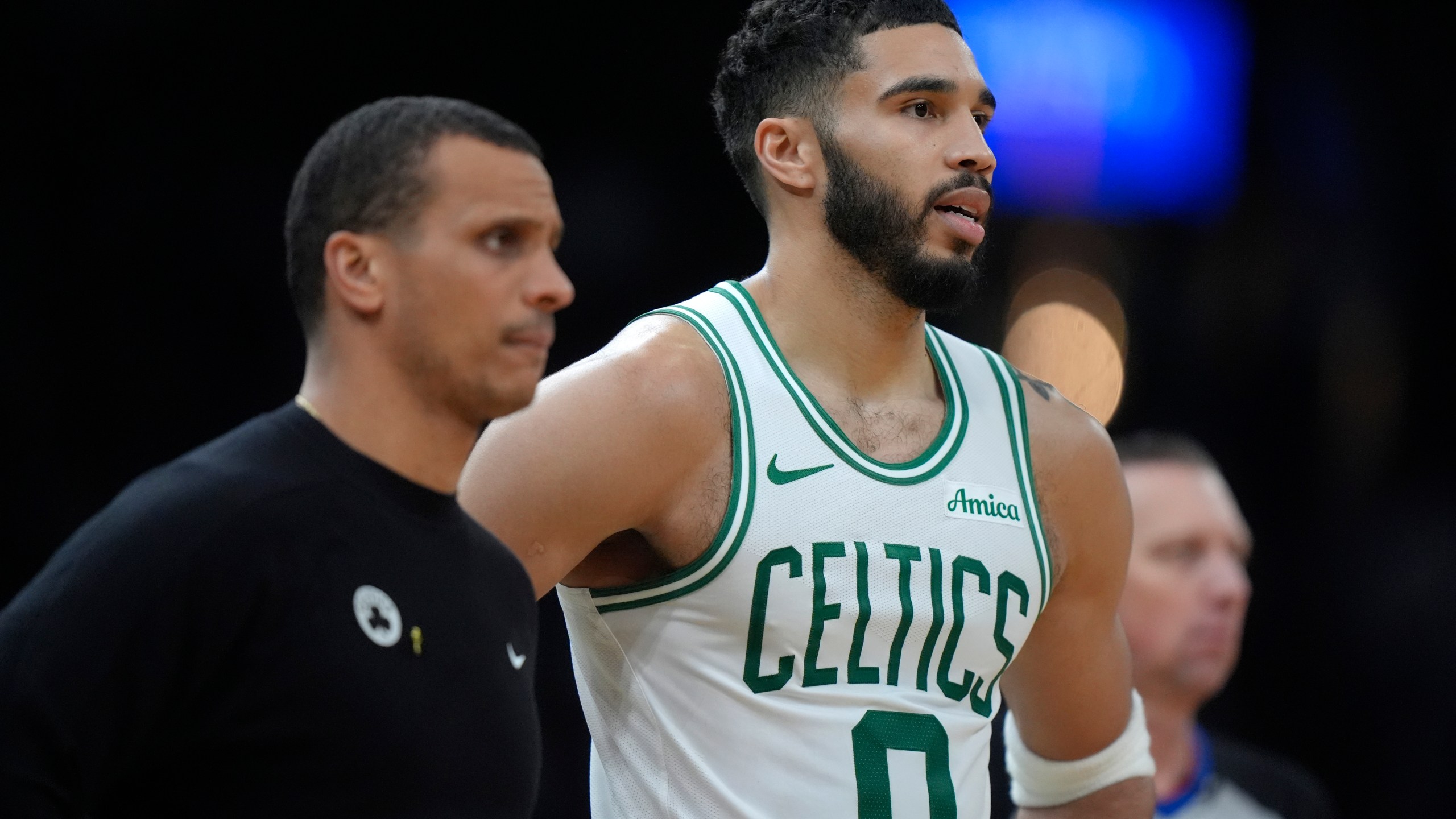 Boston Celtics head coach Joe Mazzulla, left, and forward Jayson Tatum (0) look on from the bench in the second half of an NBA basketball game against the Chicago Bulls, Thursday, Dec. 19, 2024, in Boston. (AP Photo/Steven Senne)