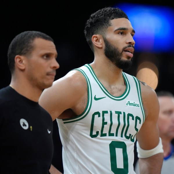 Boston Celtics head coach Joe Mazzulla, left, and forward Jayson Tatum (0) look on from the bench in the second half of an NBA basketball game against the Chicago Bulls, Thursday, Dec. 19, 2024, in Boston. (AP Photo/Steven Senne)