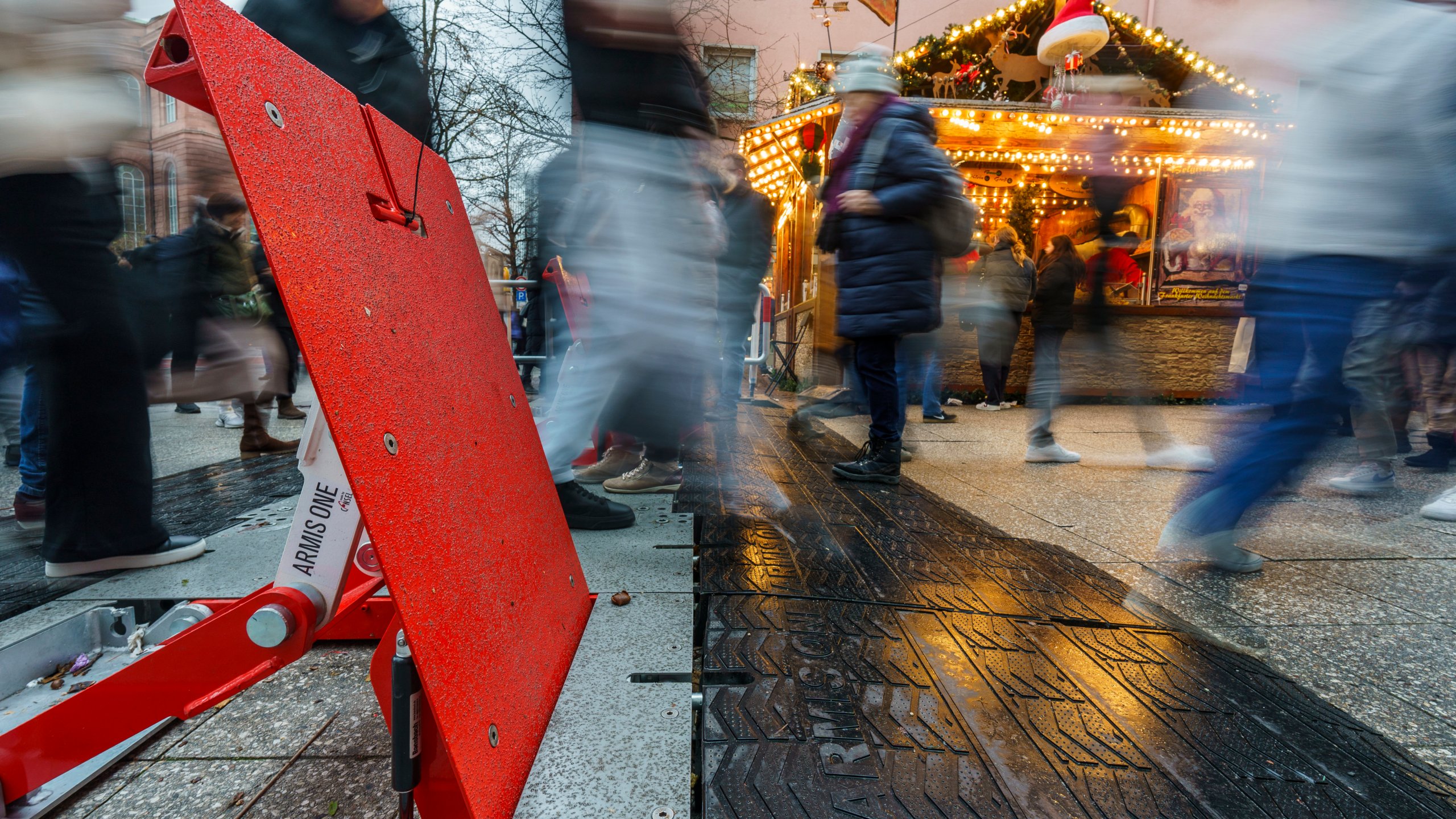 Visitors to the Frankfurt Christmas market pass through security barriers in Frankfurt, Germany, Saturday, Dec. 21, 2024. (Andreas Arnold/dpa via AP)