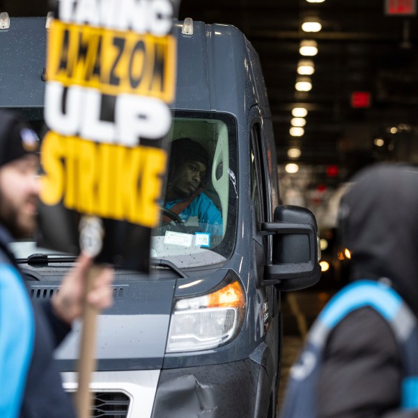 Amazon workers and members of the International Brotherhood of Teamsters picket in front of the Amazon fulfilment center in the Queens borough of in New York, on Friday, Dec. 20, 2024. (AP Photo/Stefan Jeremiah)