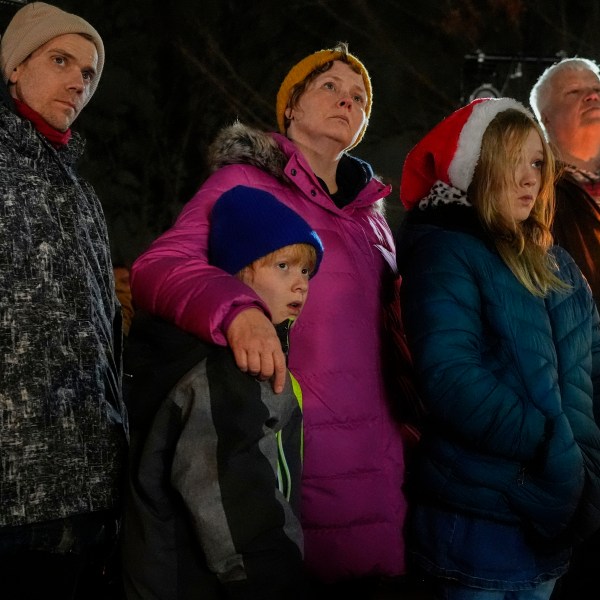 Supporters hold candles during a candlelight vigil Tuesday, Dec. 17, 2024, outside the Wisconsin Capitol in Madison, Wis., following a shooting at the Abundant Life Christian School on Monday, Dec. 16. (AP Photo/Morry Gash)