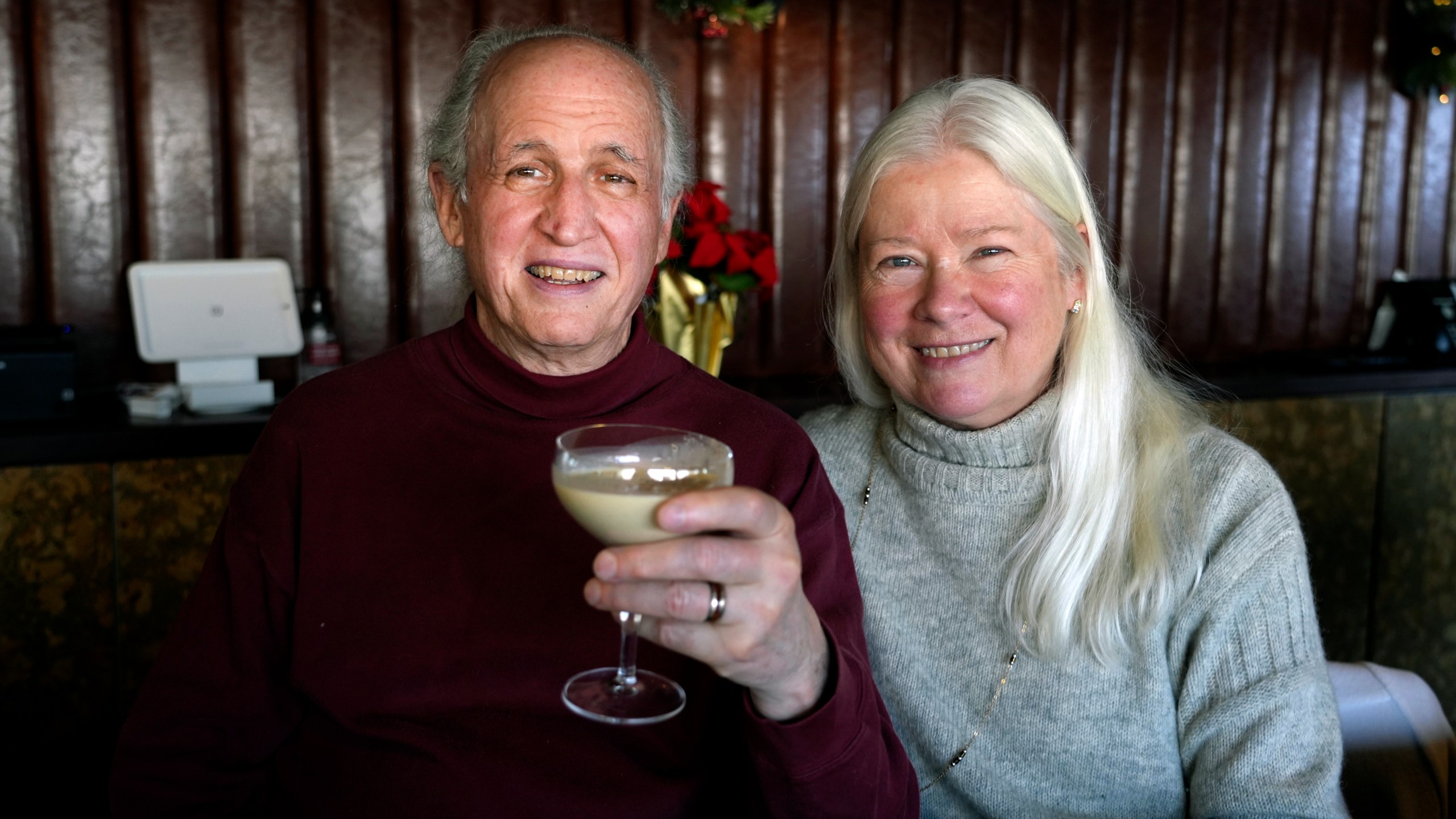 Phil and Laurie Kenny drink eggnog at Scoma's Restaurant in San Francisco on Dec. 10, 2024. The eggnog is prepared 11 months in advance. (AP Photo/Terry Chea)