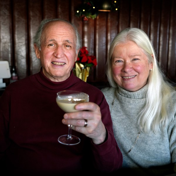 Phil and Laurie Kenny drink eggnog at Scoma's Restaurant in San Francisco on Dec. 10, 2024. The eggnog is prepared 11 months in advance. (AP Photo/Terry Chea)