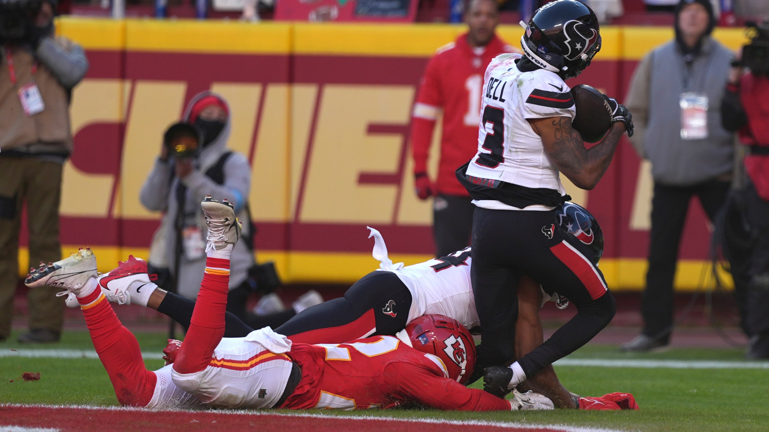 Houston Texans wide receiver Tank Dell (3) catches a touchdown pass as Kansas City Chiefs cornerback Trent McDuffie, left, defends during the second half of an NFL football game Saturday, Dec. 21, 2024, in Kansas City, Mo. Dell was injured on the play. (AP Photo/Charlie Riedel)