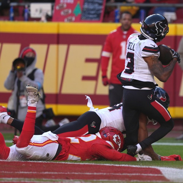 Houston Texans wide receiver Tank Dell (3) catches a touchdown pass as Kansas City Chiefs cornerback Trent McDuffie, left, defends during the second half of an NFL football game Saturday, Dec. 21, 2024, in Kansas City, Mo. Dell was injured on the play. (AP Photo/Charlie Riedel)