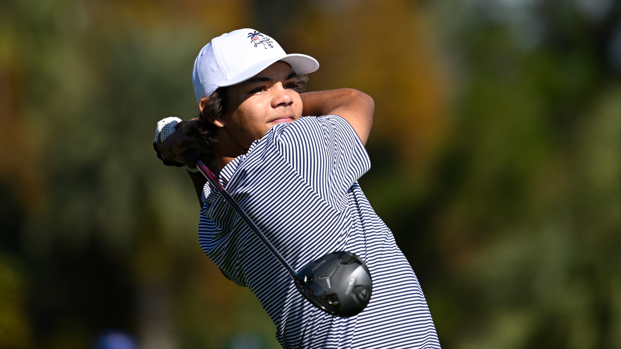 Charlie Woods tees off on the fifth hole during the first round of the PNC Championship golf tournament, Saturday, Dec. 21, 2024 in Orlando. (AP Photo/Phelan M. Ebenhack)