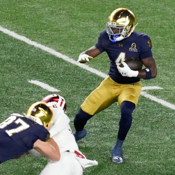 Notre Dame running back Jeremiyah Love (4) runs the ball against Indiana during the first half in the first round of the NCAA College Football Playoff, Friday, Dec. 20, 2024, in South Bend, Ind. (AP Photo/Darron Cummings)