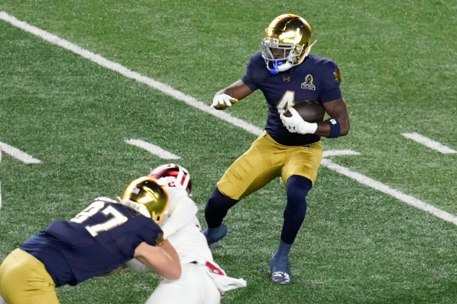 Notre Dame running back Jeremiyah Love (4) runs the ball against Indiana during the first half in the first round of the NCAA College Football Playoff, Friday, Dec. 20, 2024, in South Bend, Ind. (AP Photo/Darron Cummings)