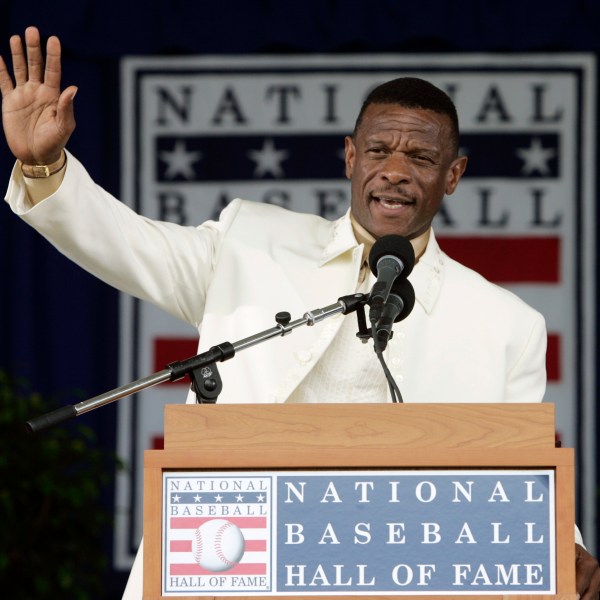 FILE - Rickey Henderson waves to the crowd during his induction speech at the Baseball Hall of Fame in Cooperstown, N.Y., July 26, 2009. (AP Photo/Mike Groll, File)