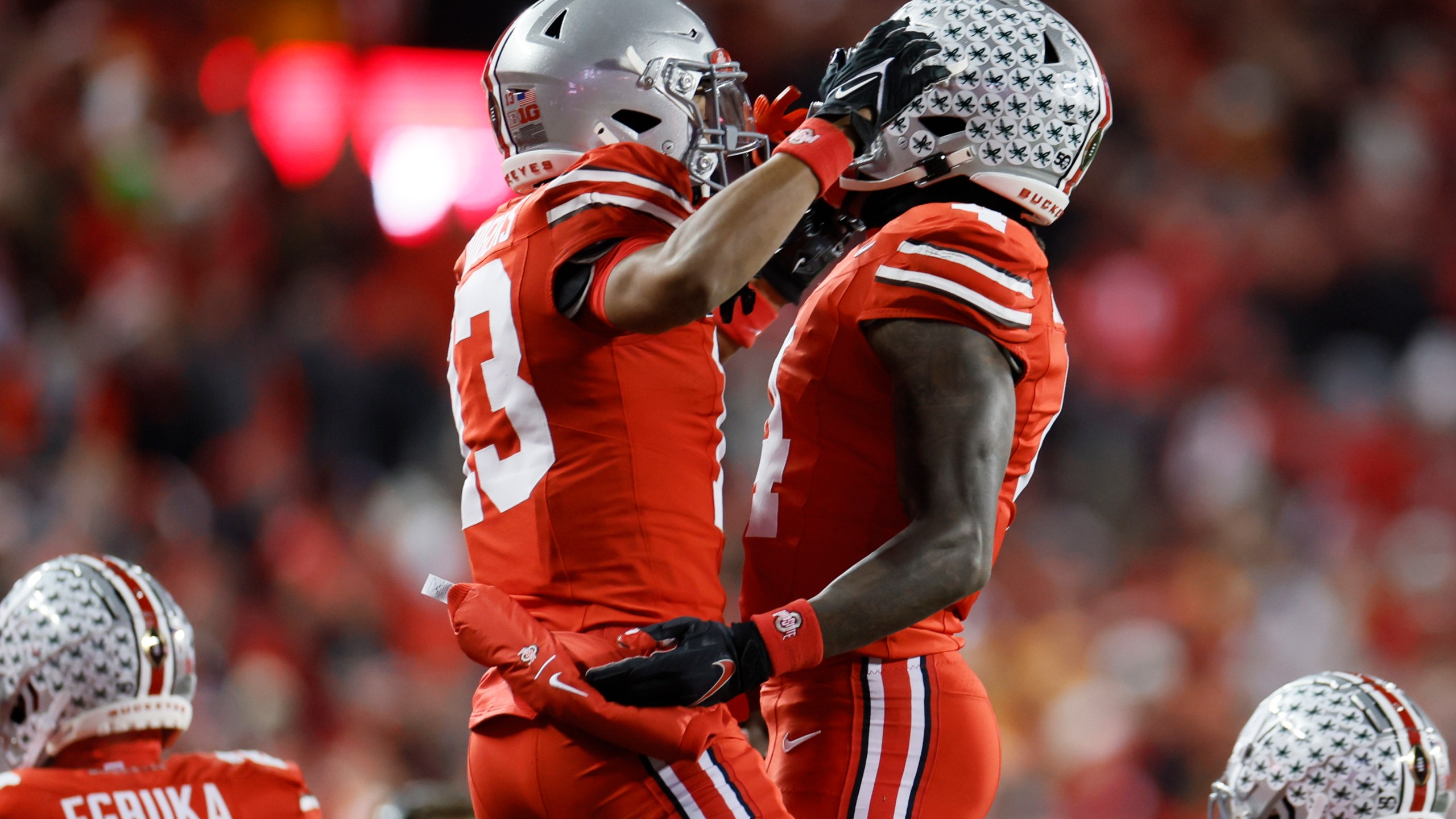 Ohio State receiver Jeremiah Smith, right, celebrates his touchdown against Tennessee with teammate Bryson Rodgers during the first half in the first round of the College Football Playoff, Saturday, Dec. 21, 2024, in Columbus, Ohio. (AP Photo/Jay LaPrete)