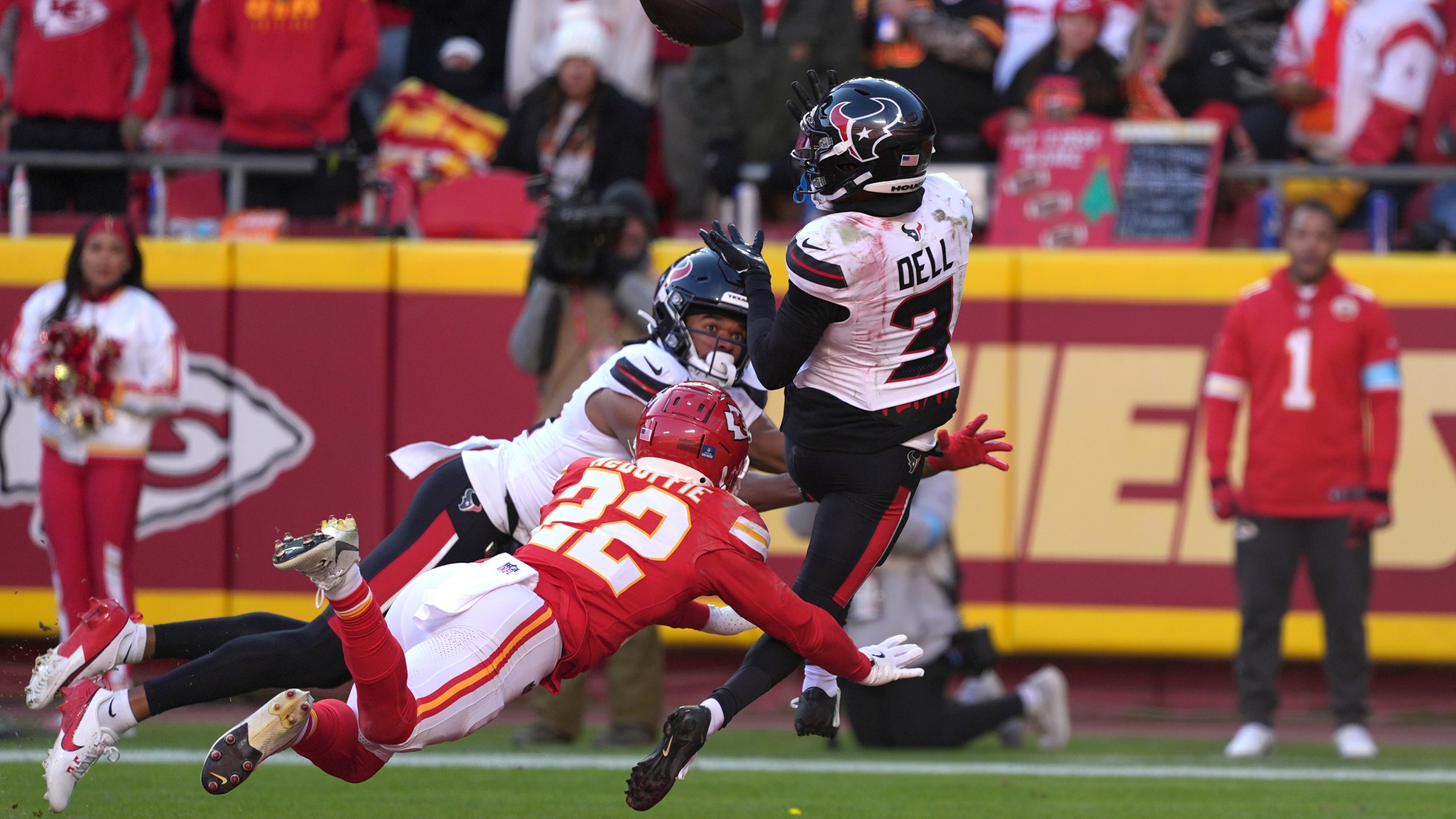 Houston Texans wide receiver Tank Dell (3) catches a touchdown pass as Kansas City Chiefs cornerback Trent McDuffie (22) defends during the second half of an NFL football game Saturday, Dec. 21, 2024, in Kansas City, Mo. Dell was injured on the play. (AP Photo/Charlie Riedel)