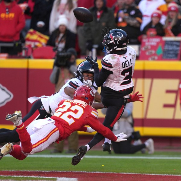 Houston Texans wide receiver Tank Dell (3) catches a touchdown pass as Kansas City Chiefs cornerback Trent McDuffie (22) defends during the second half of an NFL football game Saturday, Dec. 21, 2024, in Kansas City, Mo. Dell was injured on the play. (AP Photo/Charlie Riedel)