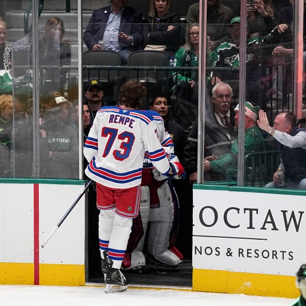 New York Rangers center Matt Rempe (73) leaves the game after being ejected for game misconduct in the third period of an NHL hockey game against the Dallas Stars in Dallas, Friday, Dec. 20, 2024. (AP Photo/Tony Gutierrez)