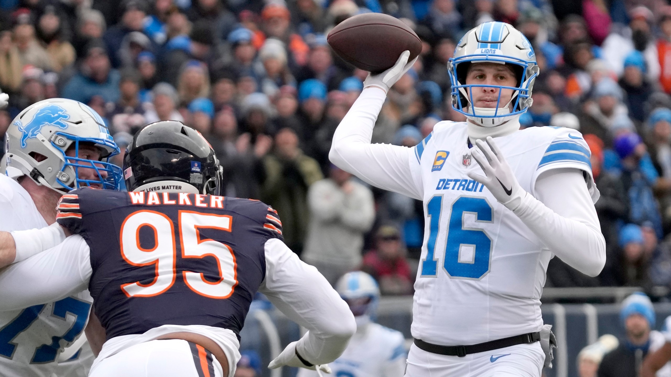 Detroit Lions quarterback Jared Goff passes under pressure from Chicago Bears defensive end DeMarcus Walker during the first half of an NFL football game Sunday, Dec. 22, 2024, in Chicago. (AP Photo/Nam Y. Huh)