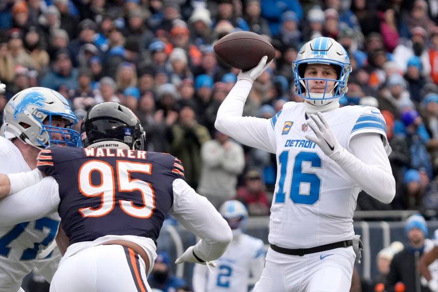 Detroit Lions quarterback Jared Goff passes under pressure from Chicago Bears defensive end DeMarcus Walker during the first half of an NFL football game Sunday, Dec. 22, 2024, in Chicago. (AP Photo/Nam Y. Huh)