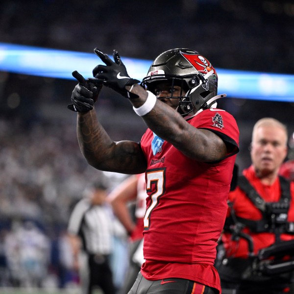 Tampa Bay Buccaneers running back Bucky Irving celebrates after rushing for a touchdown against th eDallas Cowboys in the first half of an NFL football game in Arlington, Texas, Sunday, Dec. 22, 2024. (AP Photo/Jerome Miron)