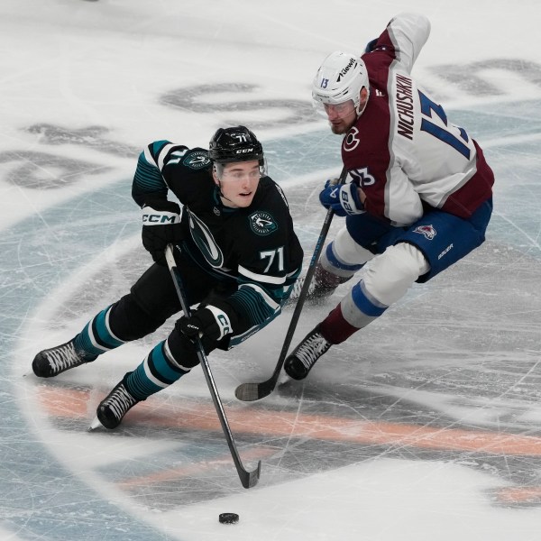 San Jose Sharks center Macklin Celebrini (71) skates with the puck against Colorado Avalanche right wing Valeri Nichushkin (13) during the third period of an NHL hockey game in San Jose, Calif., Thursday, Dec. 19, 2024. (AP Photo/Jeff Chiu)