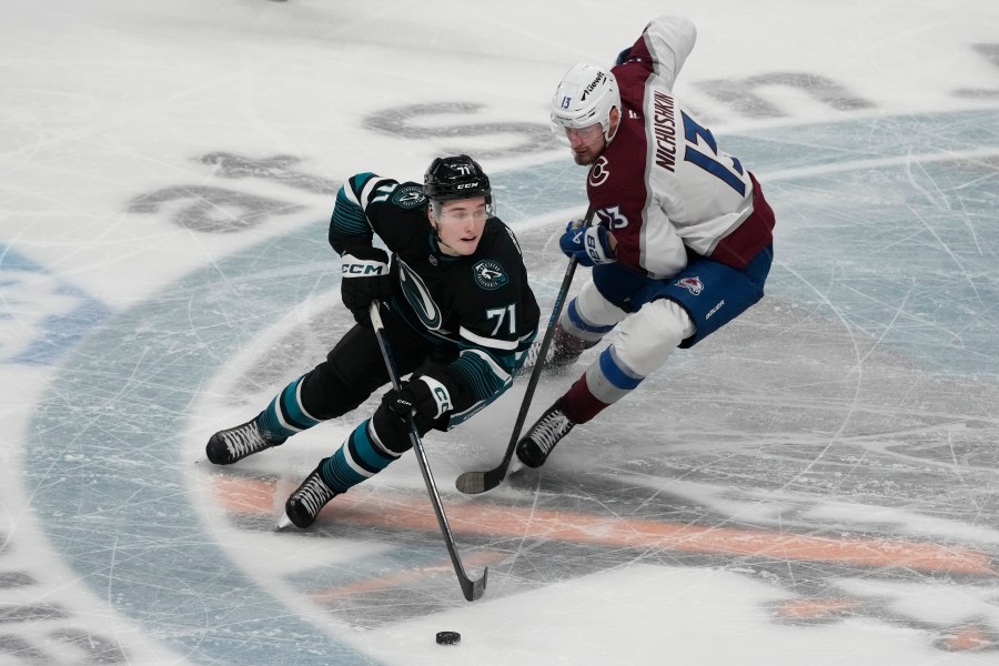 San Jose Sharks center Macklin Celebrini (71) skates with the puck against Colorado Avalanche right wing Valeri Nichushkin (13) during the third period of an NHL hockey game in San Jose, Calif., Thursday, Dec. 19, 2024. (AP Photo/Jeff Chiu)