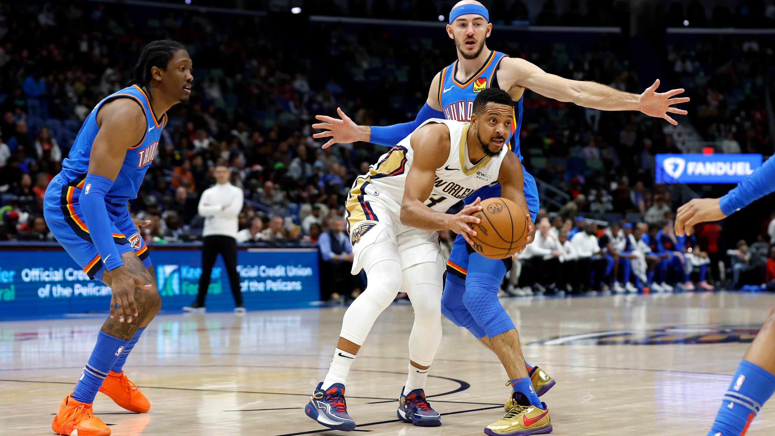 New Orleans Pelicans guard CJ McCollum (3) looks to pass the ball in front of Oklahoma City Thunder guard Alex Caruso (9) in the first half of an NBA basketball game in New Orleans, Saturday, Dec. 7, 2024. (AP Photo/Tyler Kaufman)