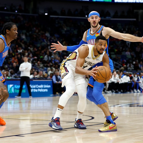 New Orleans Pelicans guard CJ McCollum (3) looks to pass the ball in front of Oklahoma City Thunder guard Alex Caruso (9) in the first half of an NBA basketball game in New Orleans, Saturday, Dec. 7, 2024. (AP Photo/Tyler Kaufman)