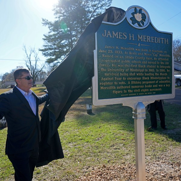 Kosciusko, Miss., Mayor Tim Kyle, unveils a Mississippi Department of Archives and History marker recognizing the birthplace and civil rights movement legacy of James Meredith, who became the first Black student to enroll at the University of Mississippi in 1962, Friday, Dec. 20, 2024, in Kosciusko, Miss. (AP Photo/Rogelio V. Solis)