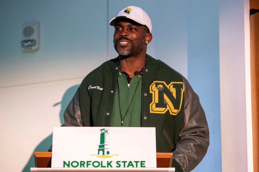 Michael Vick speaks to media and attendees after he is introduced as the head coach of the Norfolk State football team during a press conference on Monday, Dec. 23, 2024 in Norfolk, Va. (AP Photo/Mike Caudill)