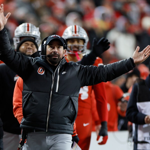 Ohio State head coach Ryan Day, front, reacts to the video replay during the first half in the first round of the College Football Playoff against Tennessee, Saturday, Dec. 21, 2024, in Columbus, Ohio. (AP Photo/Jay LaPrete)