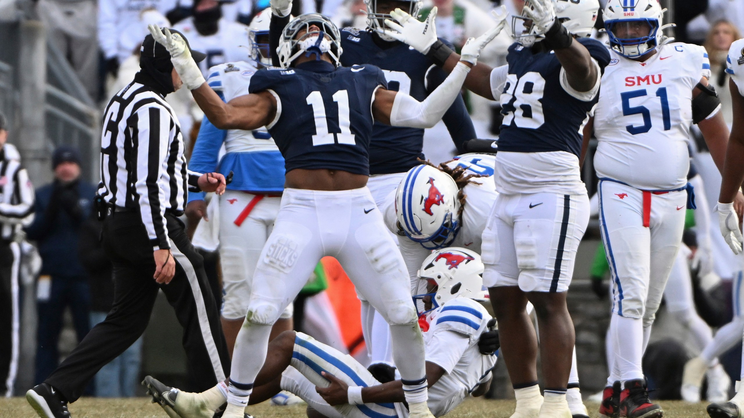 Penn State defensive end Abdul Carter (11) celebrates after sacking SMU quarterback Kevin Jennings during the second half in the first round of the College Football Playoff, Saturday, Dec. 21, 2024, in State College, Pa. (AP Photo/Barry Reeger)