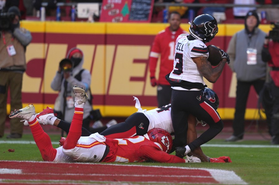 Houston Texans wide receiver Tank Dell (3) catches a touchdown pass as Kansas City Chiefs cornerback Trent McDuffie, left, defends during the second half of an NFL football game Saturday, Dec. 21, 2024, in Kansas City, Mo. Dell was injured on the play. (AP Photo/Charlie Riedel)