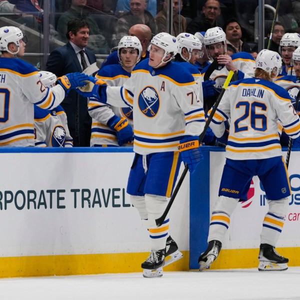 Buffalo Sabres' Tage Thompson (72) celebrates with teammates after scoring an empty-net goal during the third period of an NHL hockey game against the New York Islanders Monday, Dec. 23, 2024, in Elmont, N.Y. (AP Photo/Frank Franklin II)